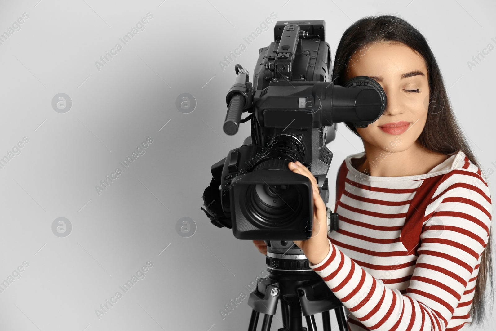 Photo of Operator with professional video camera on white background