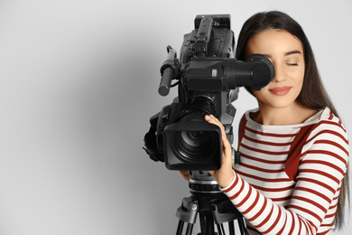 Photo of Operator with professional video camera on white background