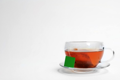 Hot tea in glass cup on white background