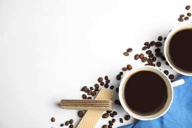 Photo of Breakfast with delicious wafers and coffee on white background, flat lay. Space for text