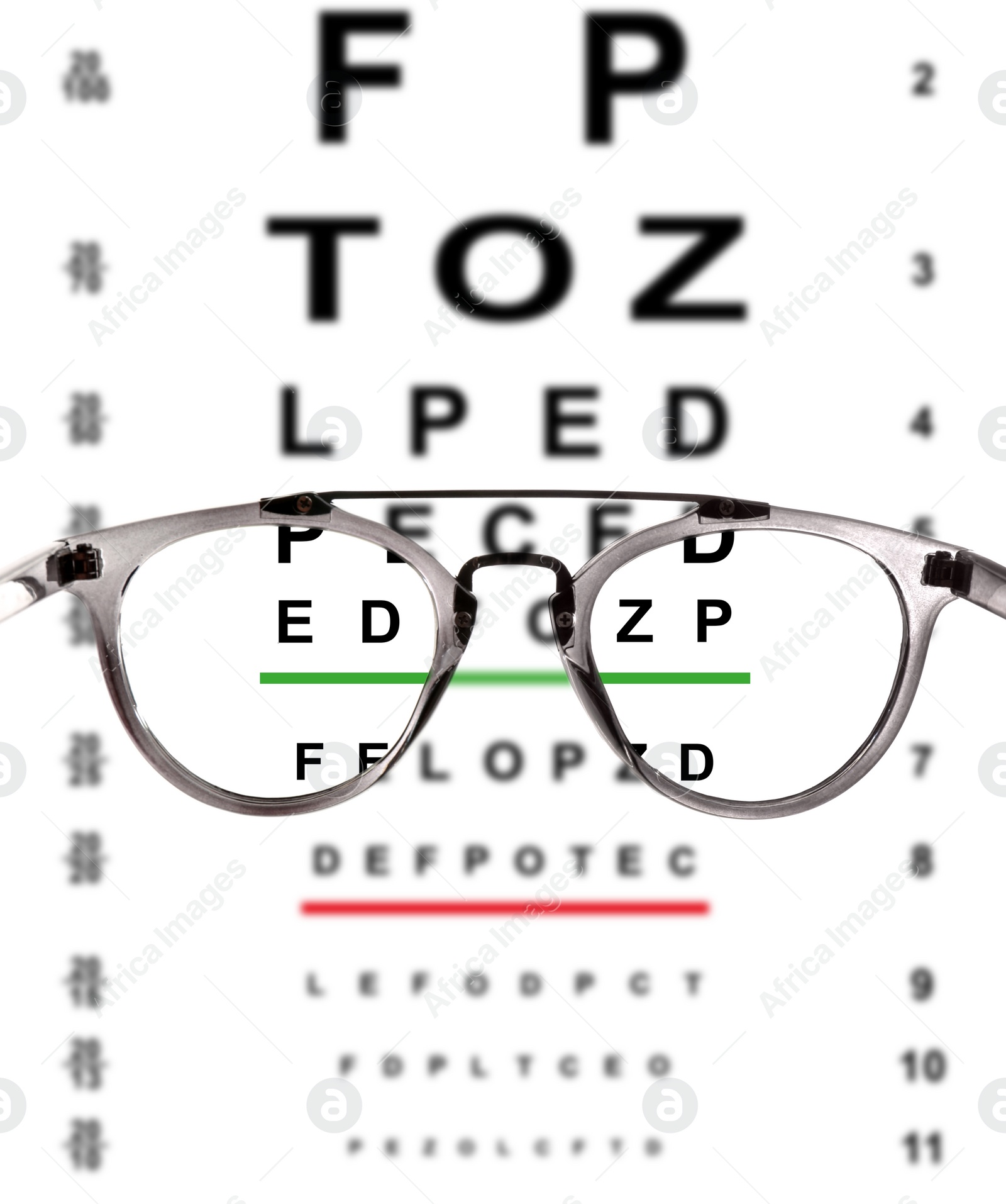 Image of View through glasses on eye chart, white background