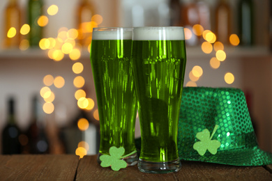 Green beer, clover and hat on wooden counter. St.Patrick's Day celebration