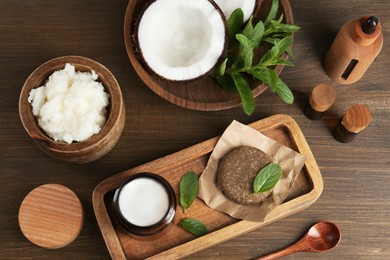 Photo of Flat lay composition with homemade cosmetic products and fresh ingredients on wooden table