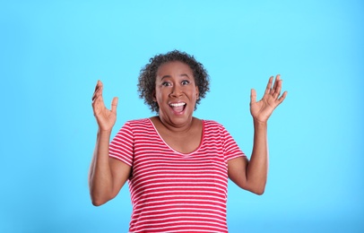 Photo of Portrait of happy African-American woman on light blue background