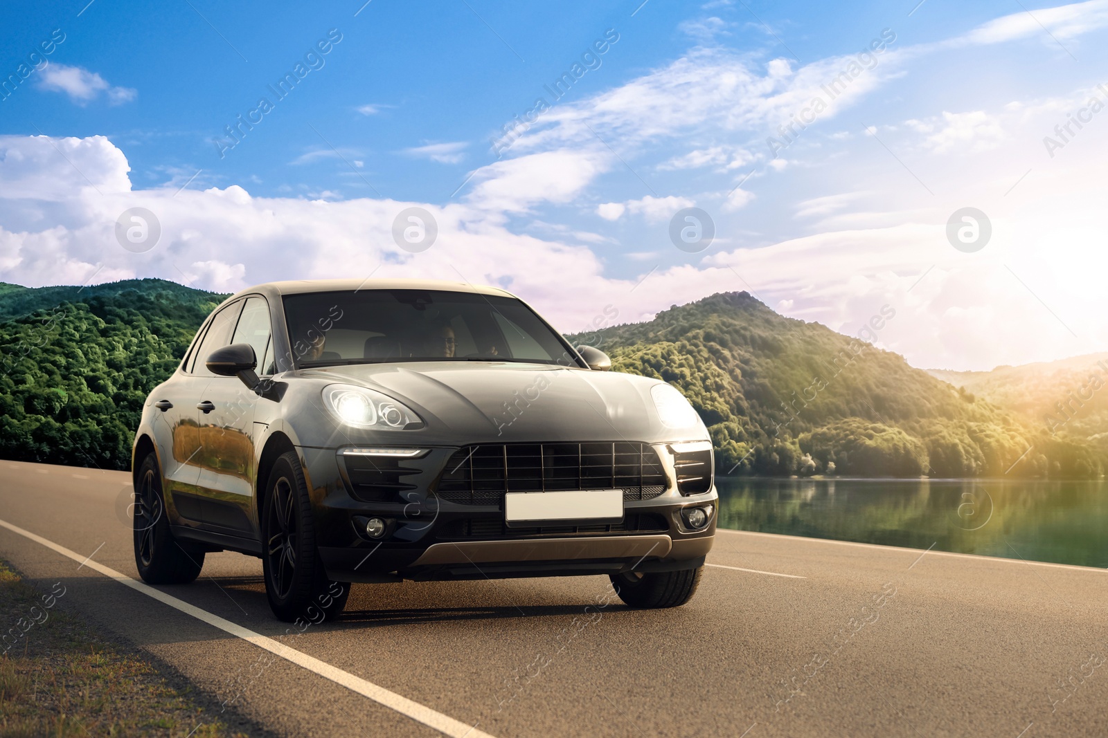 Image of Modern car on asphalt road in mountains