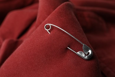 Closeup view of metal safety pin on clothing