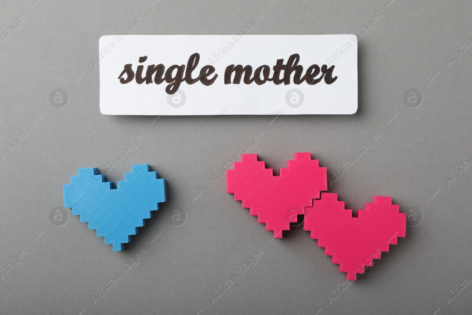 Photo of Hearts and text Single mother on grey background, flat lay