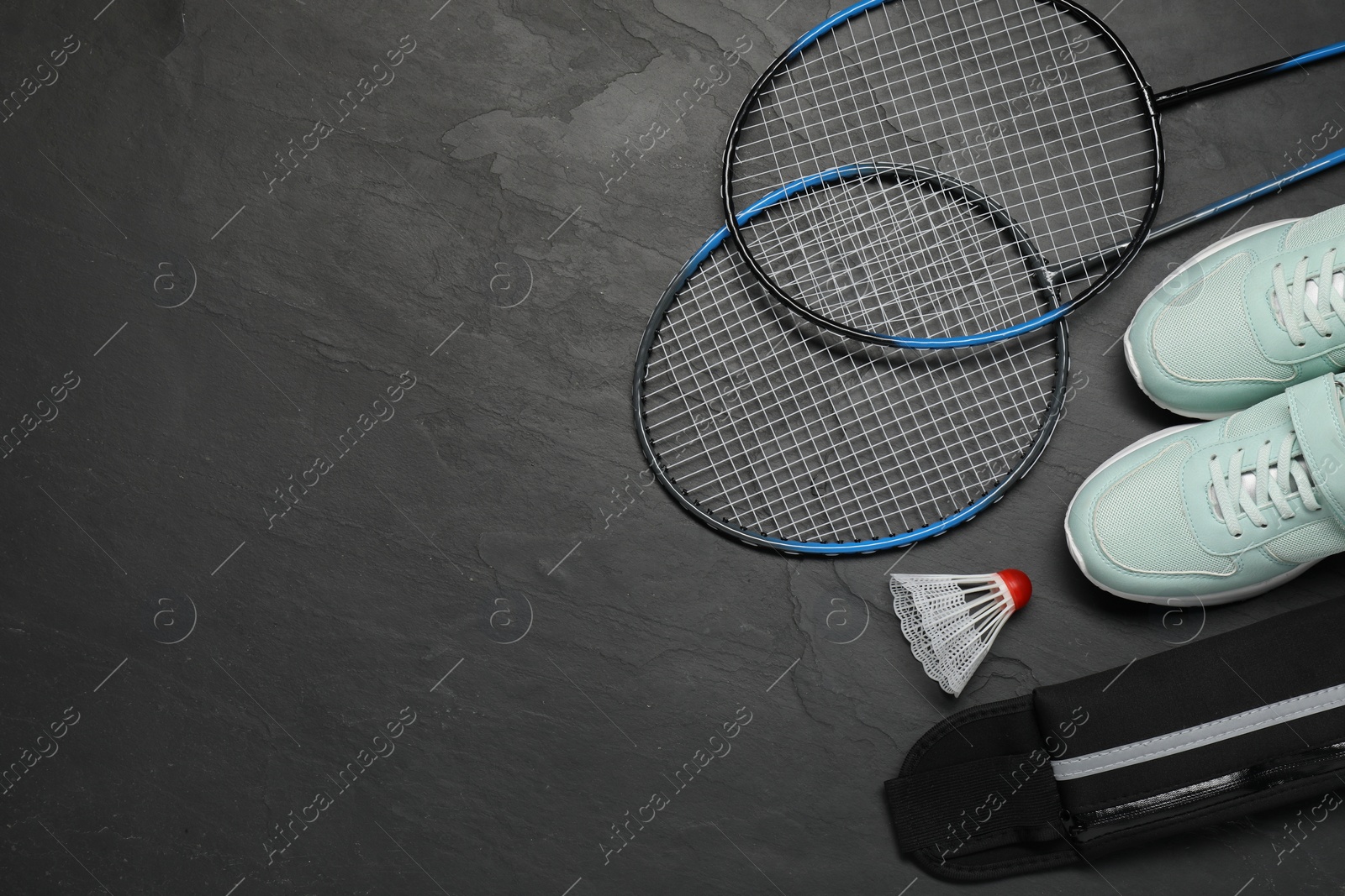 Photo of Different sports equipment on black table, flat lay. Space for text
