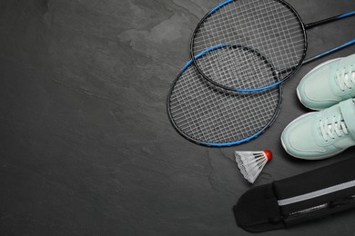 Different sports equipment on black table, flat lay. Space for text