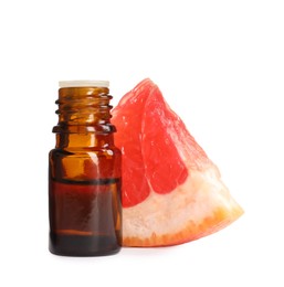 Photo of Bottle of citrus essential oil and fresh grapefruit slice on white background