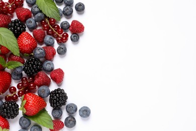 Many different fresh berries and mint leaves on white background, flat lay. Space for text