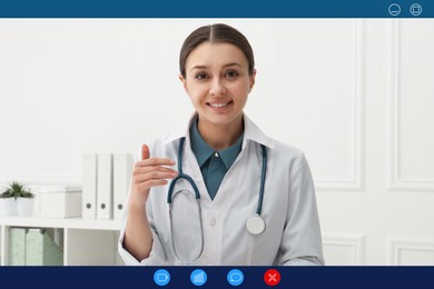 Pediatrician consulting patient online using video chat in clinic, view from webcam