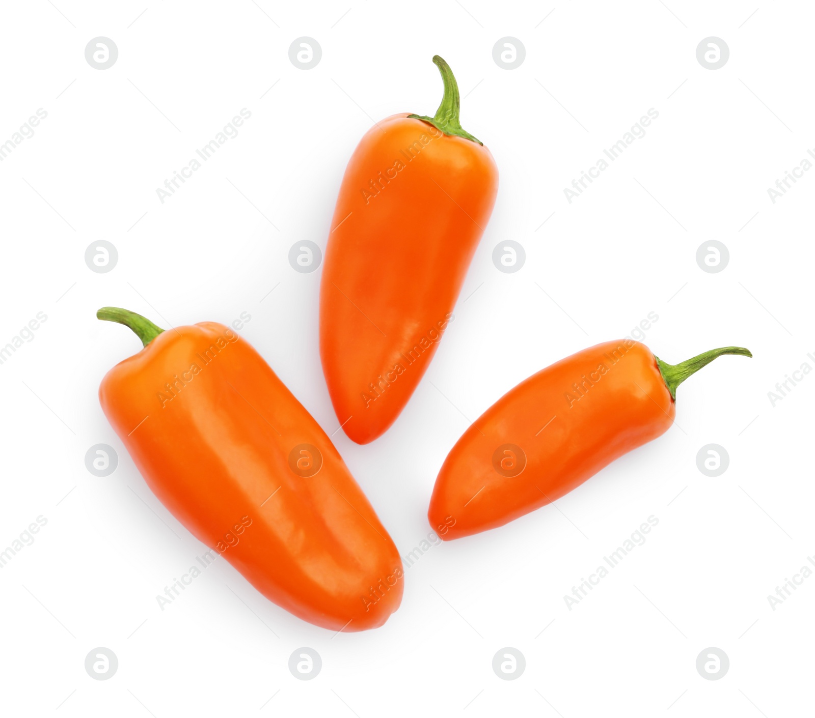 Photo of Fresh raw orange hot chili peppers isolated on white, top view