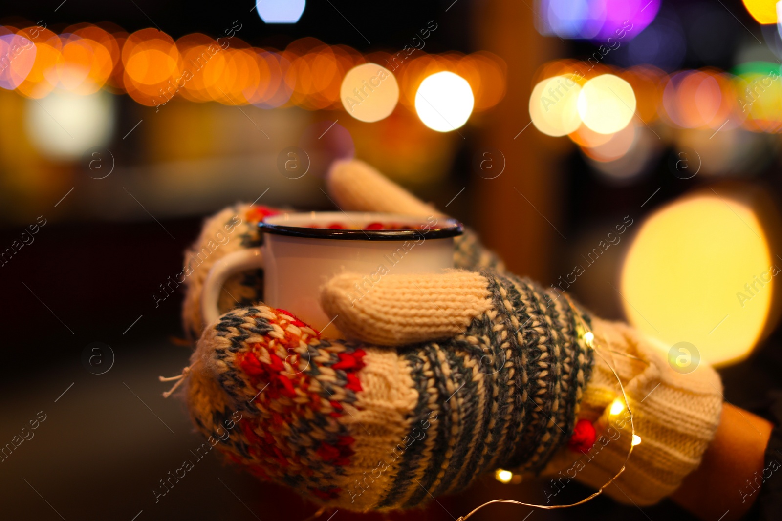 Photo of Woman with mulled wine at winter fair, closeup