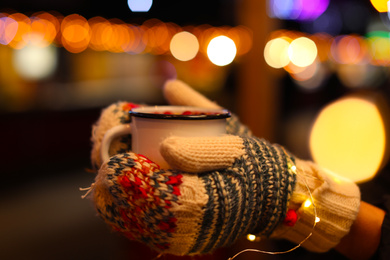 Photo of Woman with mulled wine at winter fair, closeup