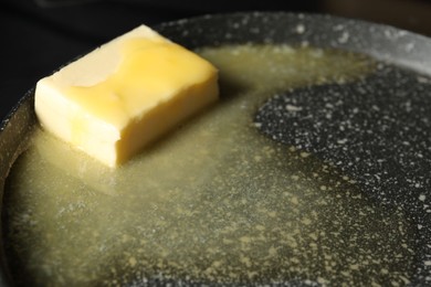 Photo of Melting butter in frying pan, closeup view