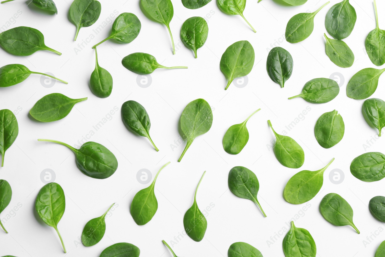 Photo of Fresh green leaves of healthy baby spinach on white background, top view