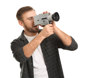 Young man using vintage video camera on white background