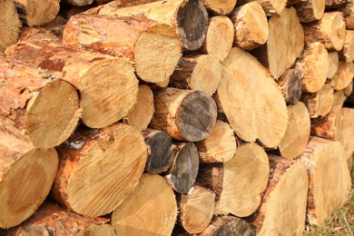 Stacked firewood outdoors, closeup. Heating in winter