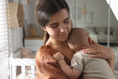 Happy young mother with her baby at home