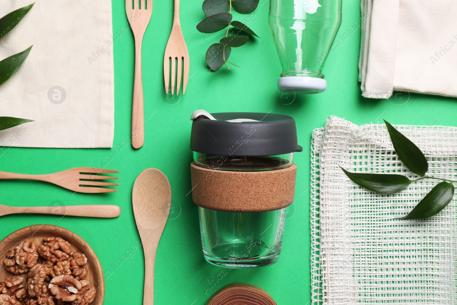 Photo of Flat lay composition with eco friendly products on green background