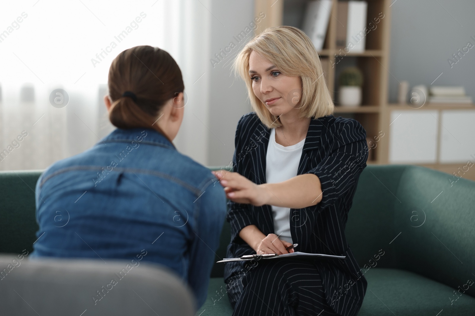 Photo of Professional psychotherapist working with patient in office