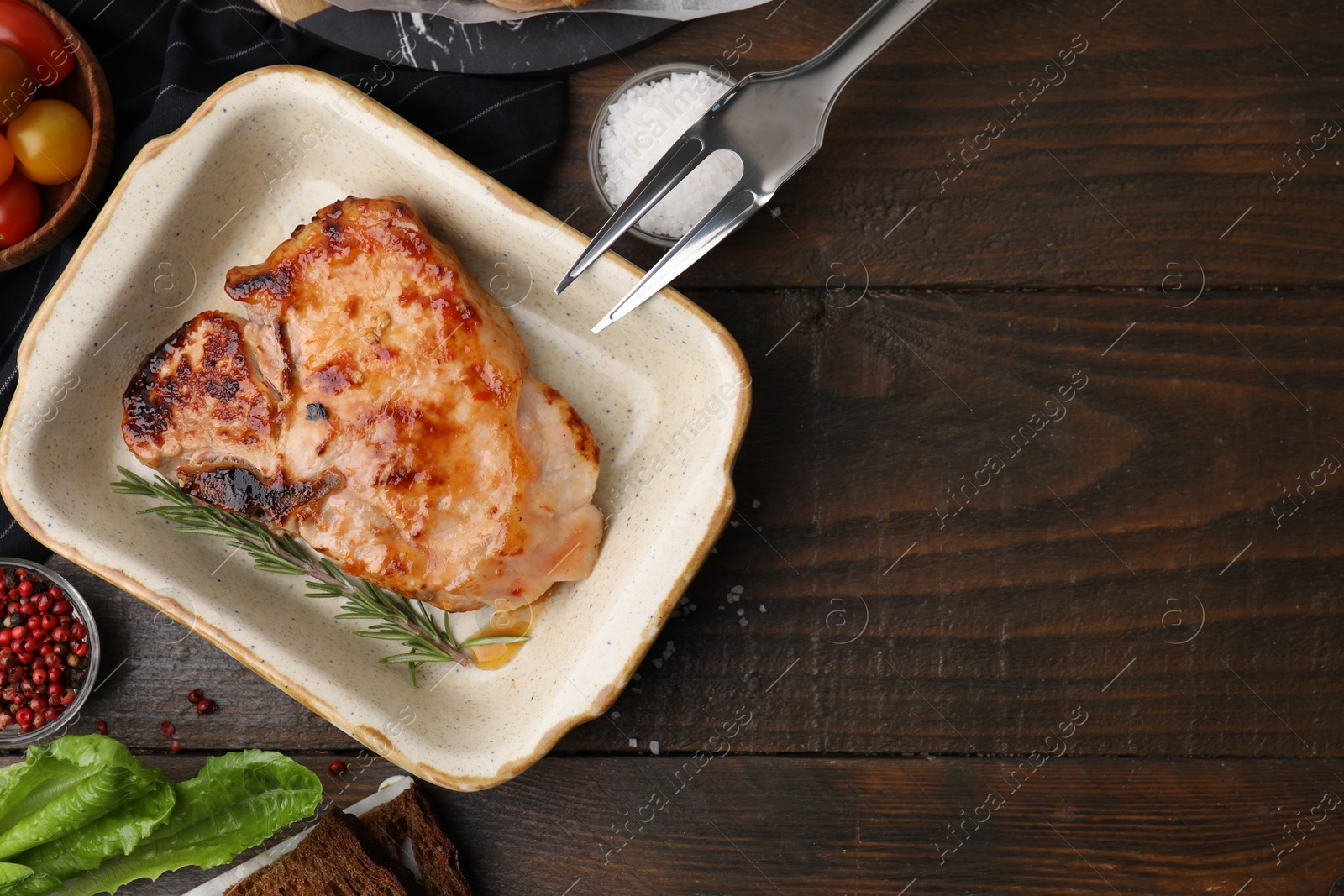 Photo of Tasty marinated meat, rosemary and spices on wooden table, flat lay. Space for text