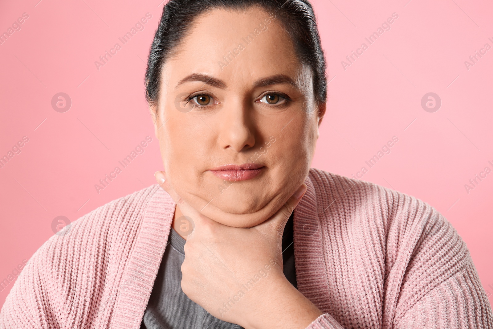 Photo of Woman with double chin on pink background