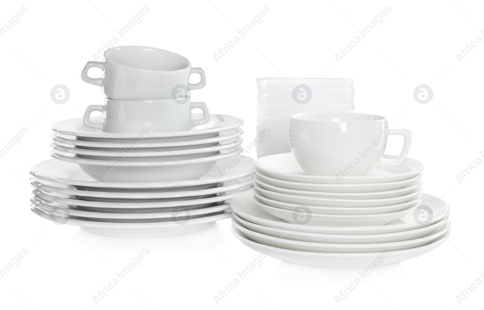 Photo of Stacked plates and cups on white background