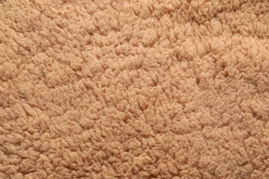 Texture of brown faux fur as background, closeup