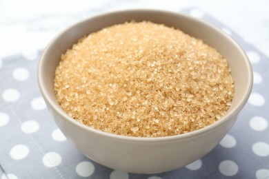 Brown sugar in bowl on table, closeup