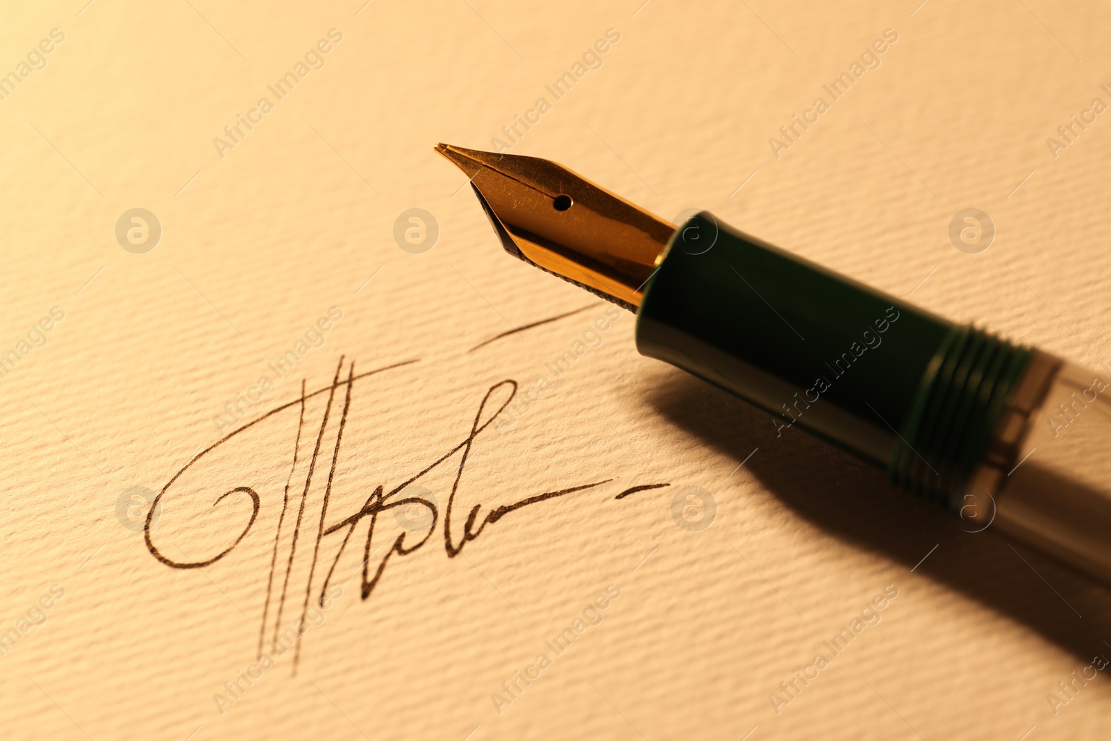 Photo of Sheet of paper with fountain pen and signature, closeup