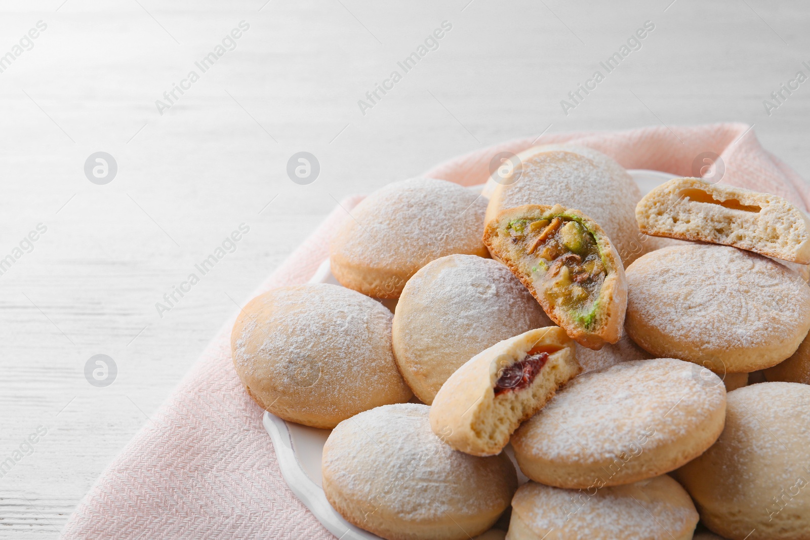 Photo of Traditional Islamic cookies on wooden table, space for text. Eid Mubarak