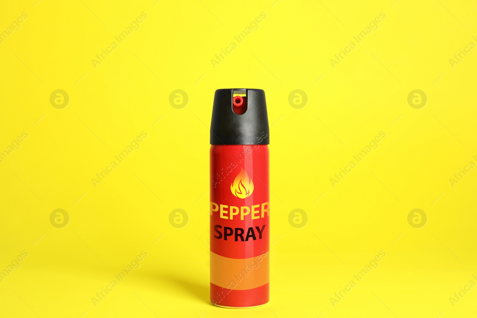 Image of Bottle of gas pepper spray on yellow background