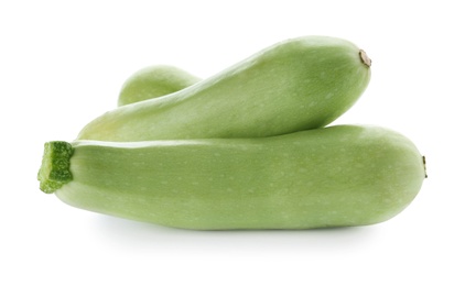 Fresh ripe zucchini squashes on white background