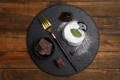 Photo of Delicious fresh fondant with hot chocolate and mint on wooden table, top view
