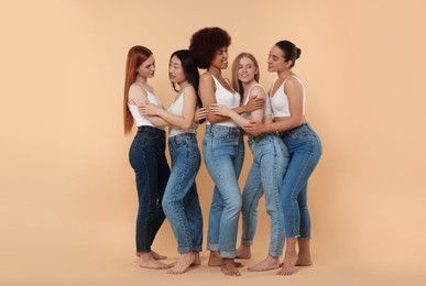 Group of beautiful young women on beige background