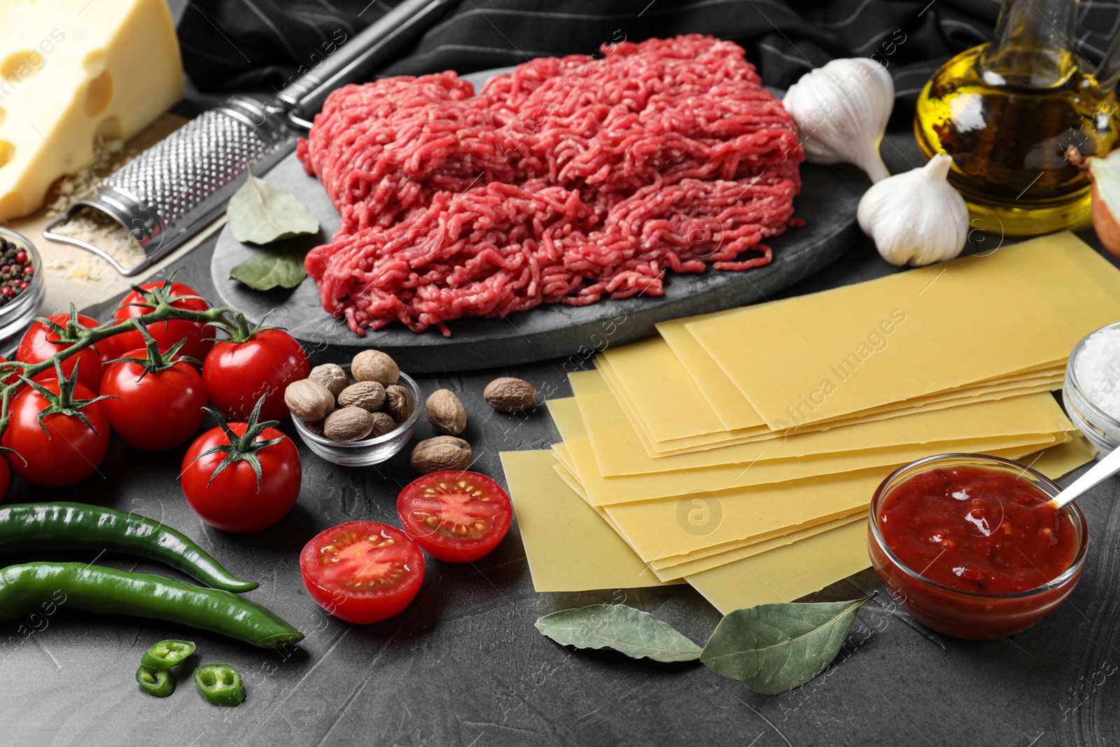 Photo of Fresh ingredients for lasagna on grey table