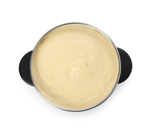 Fondue pot with tasty melted cheese isolated on white, top view