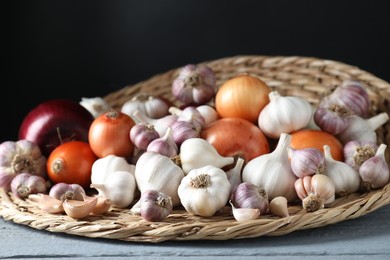 Photo of Fresh raw garlic and onions on gray wooden table