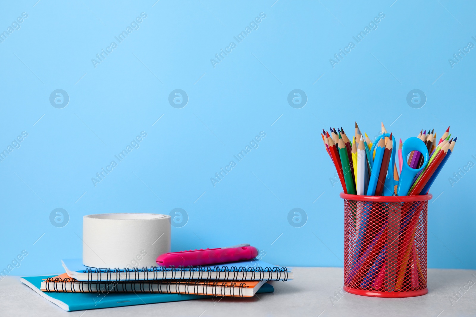 Photo of Different school stationery on table against light blue background. Back to school