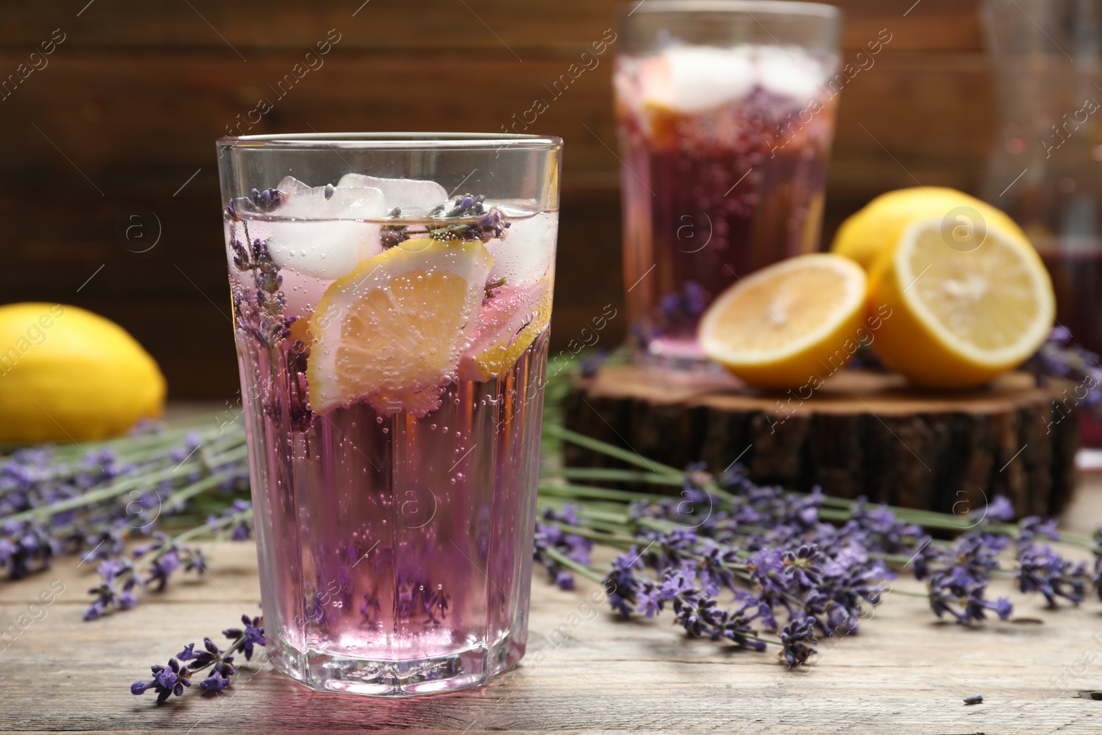 Photo of Fresh delicious lemonade with lavender on wooden table. Space for text