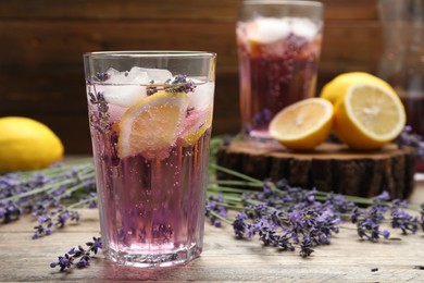 Photo of Fresh delicious lemonade with lavender on wooden table. Space for text