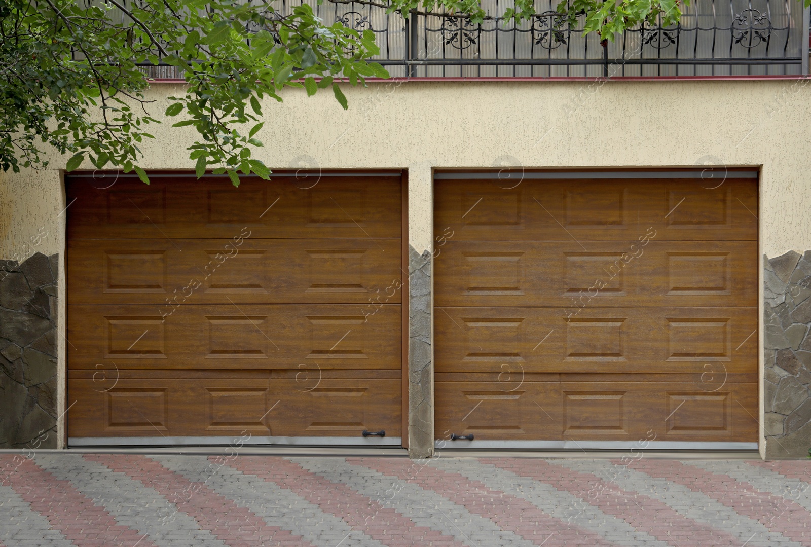 Photo of Building with brown sectional garage doors and paved driveway