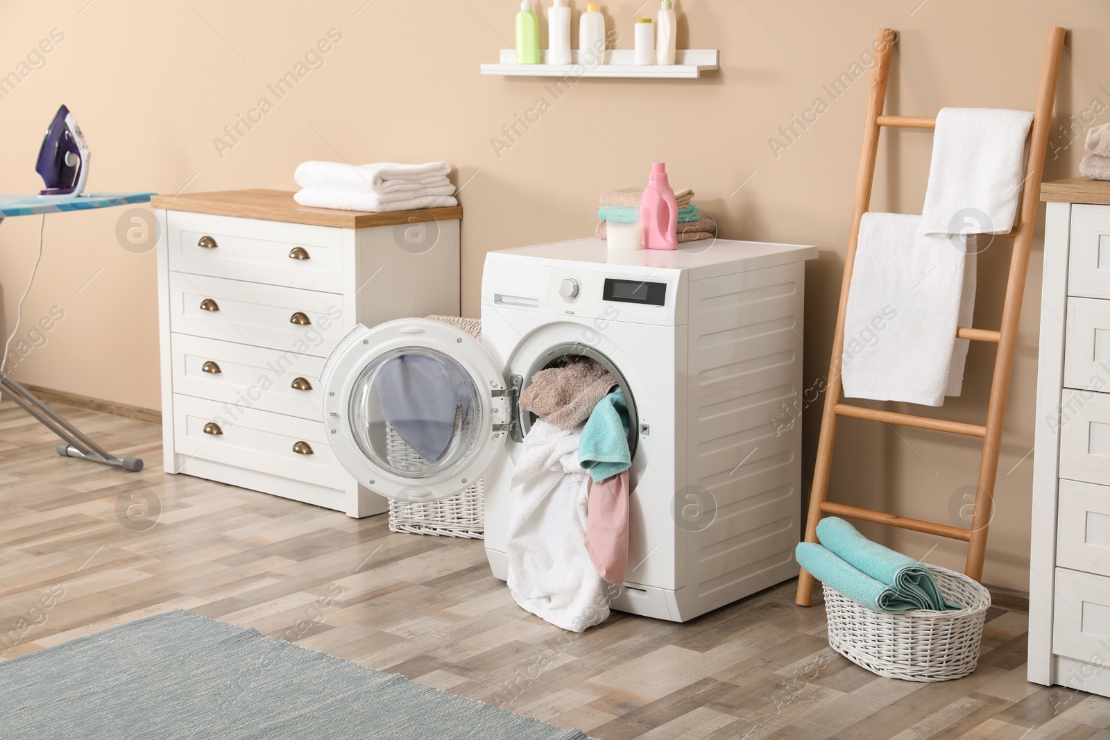 Photo of Bathroom interior with dirty towels in washing machine