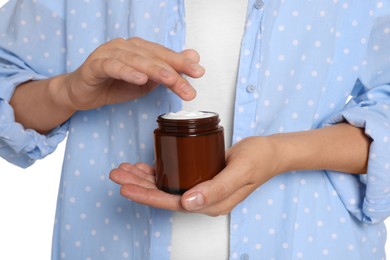 Photo of Woman taking hand cream from jar on white background, closeup