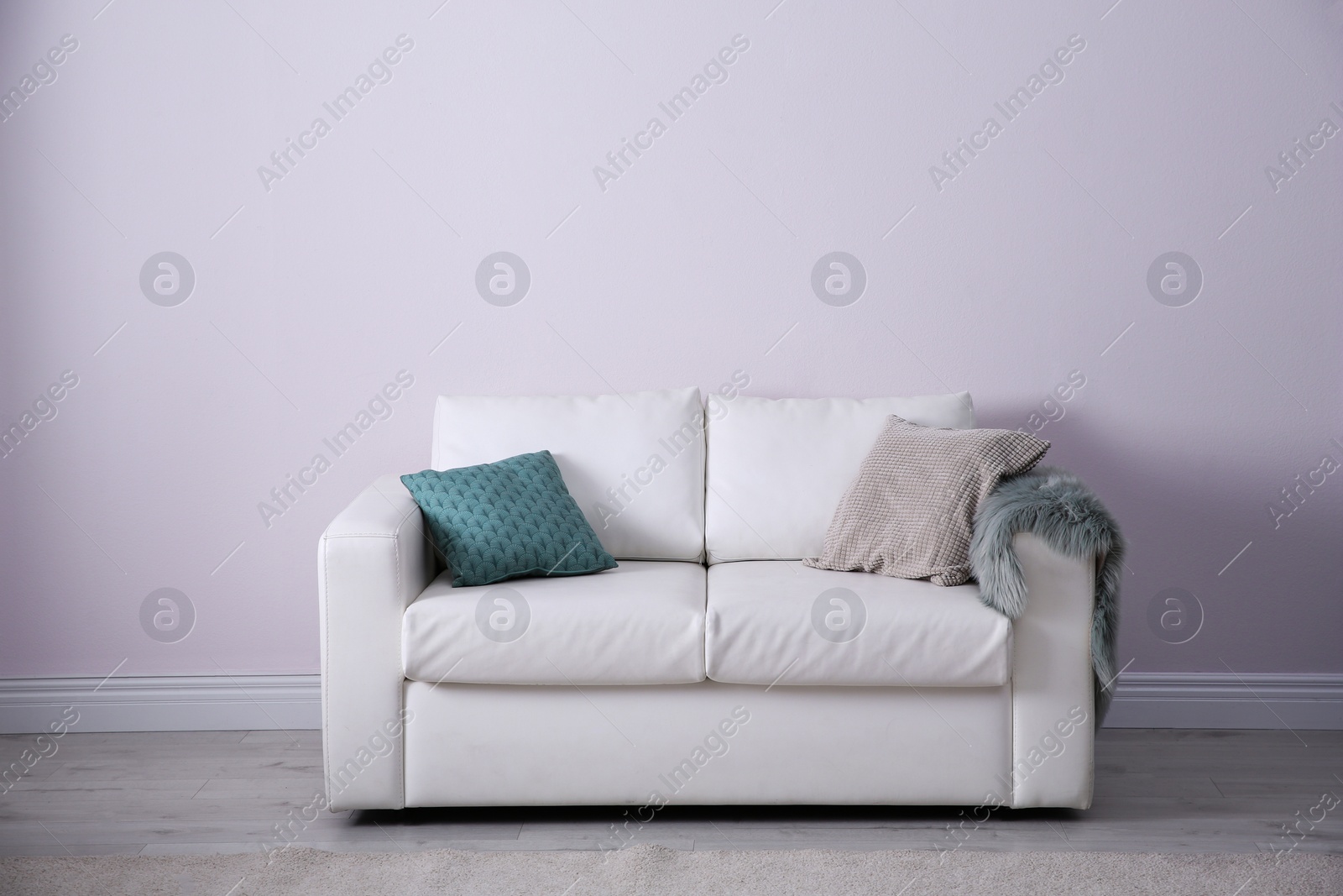 Photo of Simple living room interior with comfortable sofa near white wall. Space for text