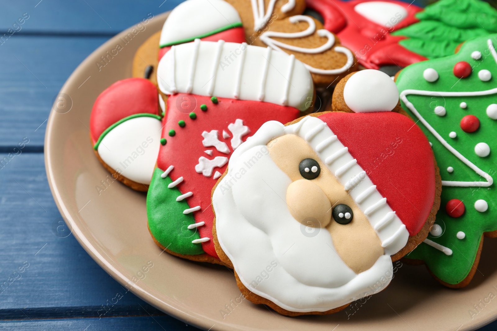 Photo of Different tasty Christmas cookies on blue wooden table, closeup