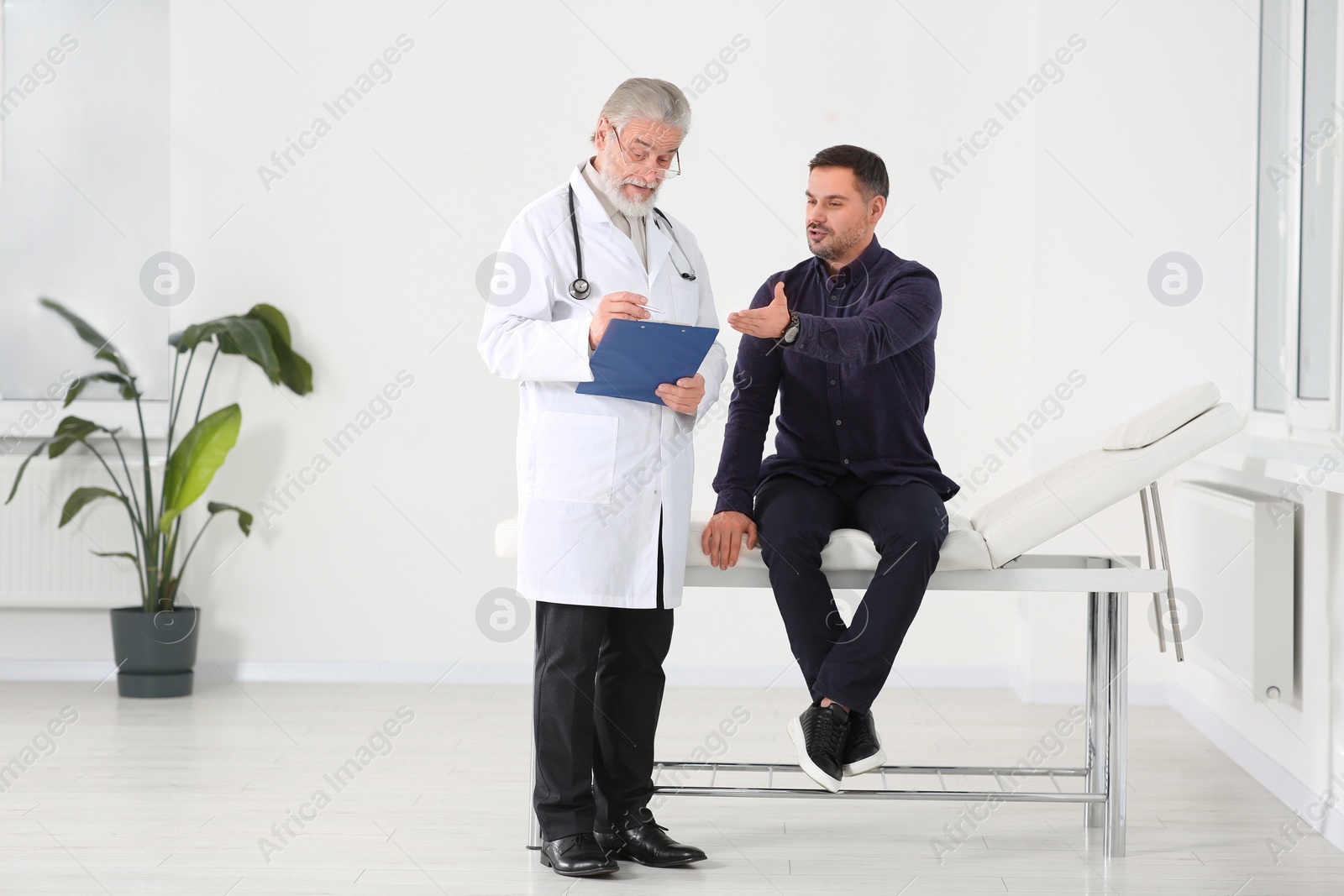 Photo of Patient having appointment with senior doctor in clinic