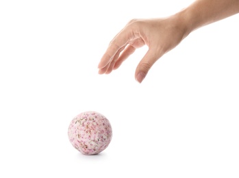 Photo of Woman reaching for bath bomb on white background, closeup